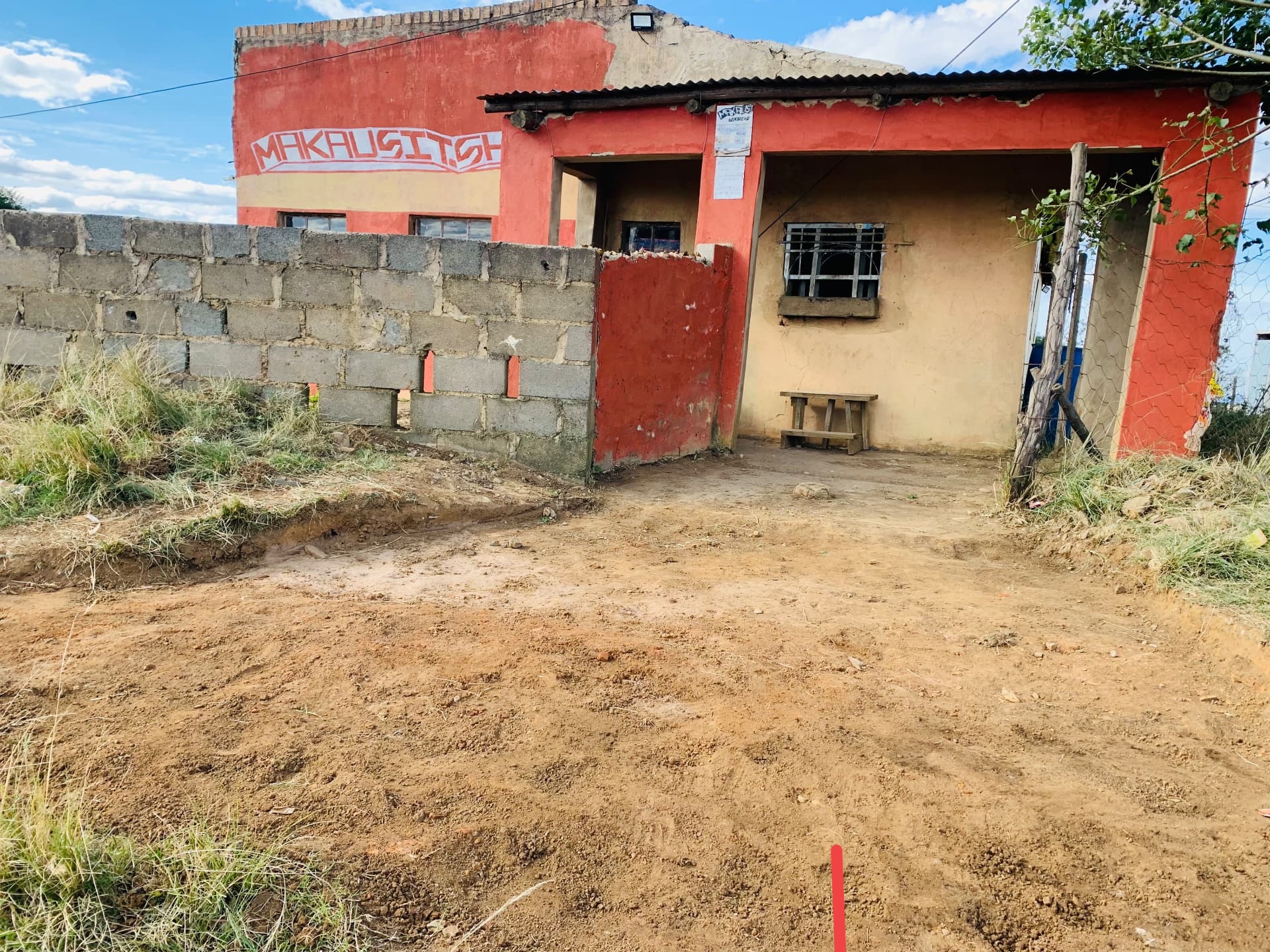 The red-painted Makausi Enterprise shop building on the R61 in Mpetshwa